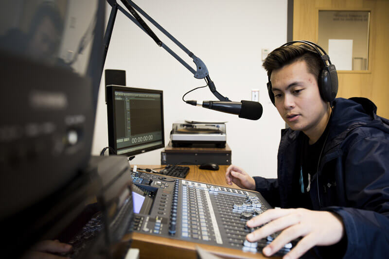 Student in broadcasting booth