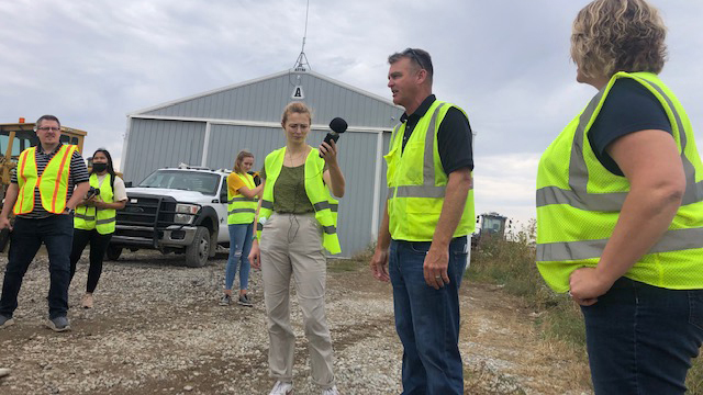 Students conduct interview at landfill