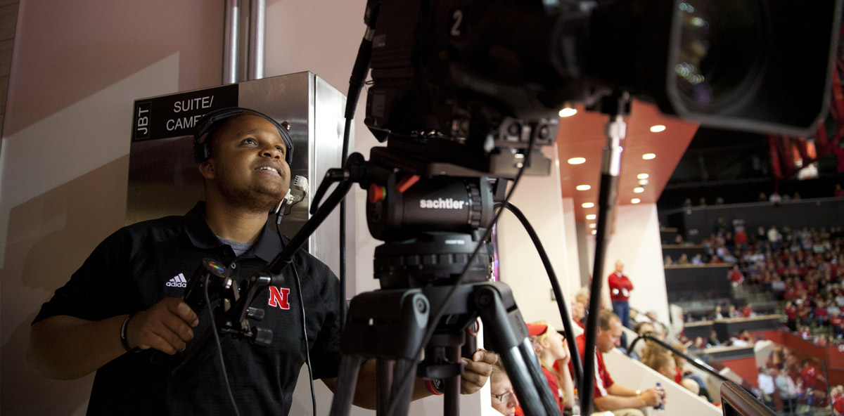 Student working in sports broadcasting during basketball game