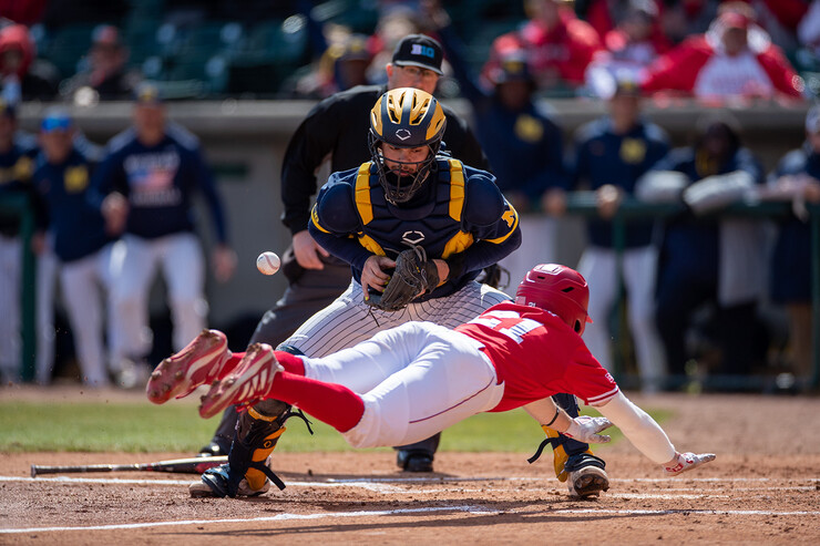 One of Dillon Galloway's favorite pictures from the internship is this one of a Husker baseball player sliding into home plate ahead of the relay to the Michigan catcher.