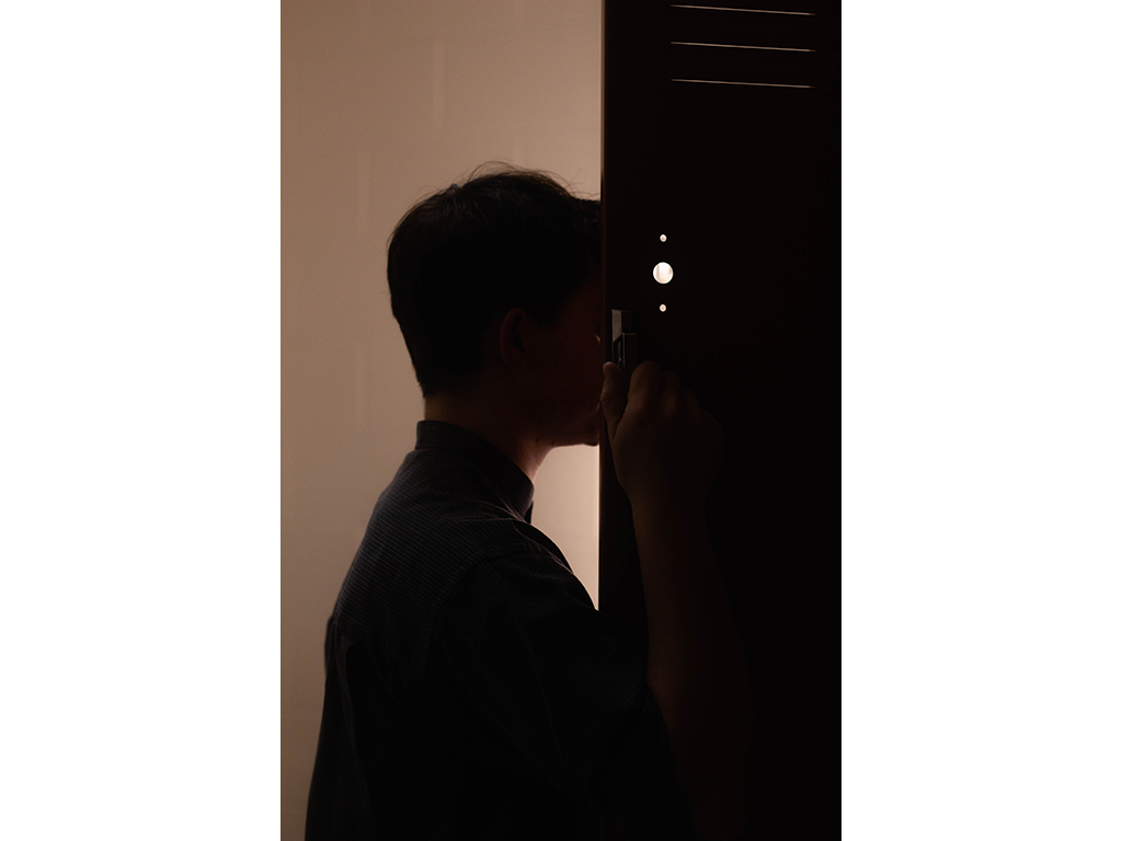 Anonymous man opens locker door