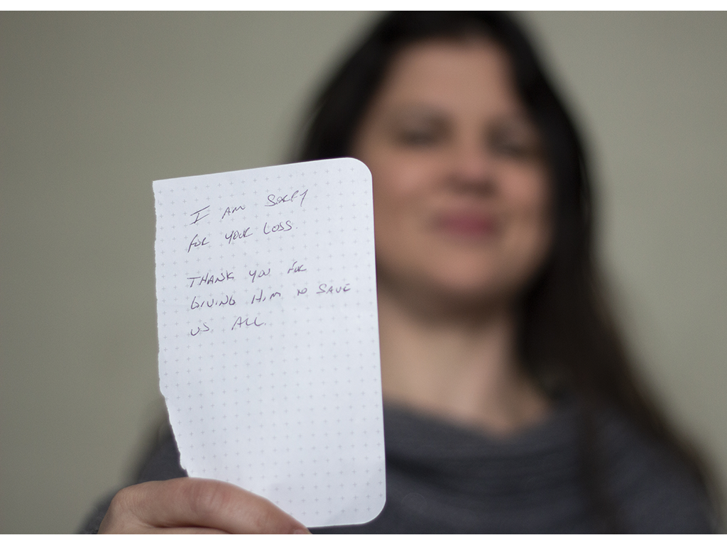 woman holds note