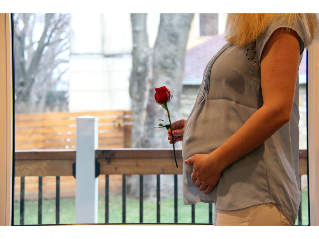 Pregnant woman hold rose