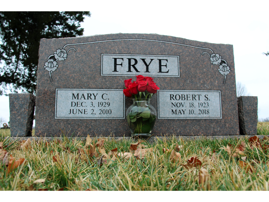 Grave stones with bouquet of roses