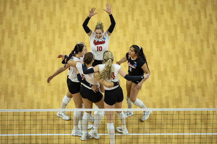 The Husker volleyball team celebrates a point against Kansas.