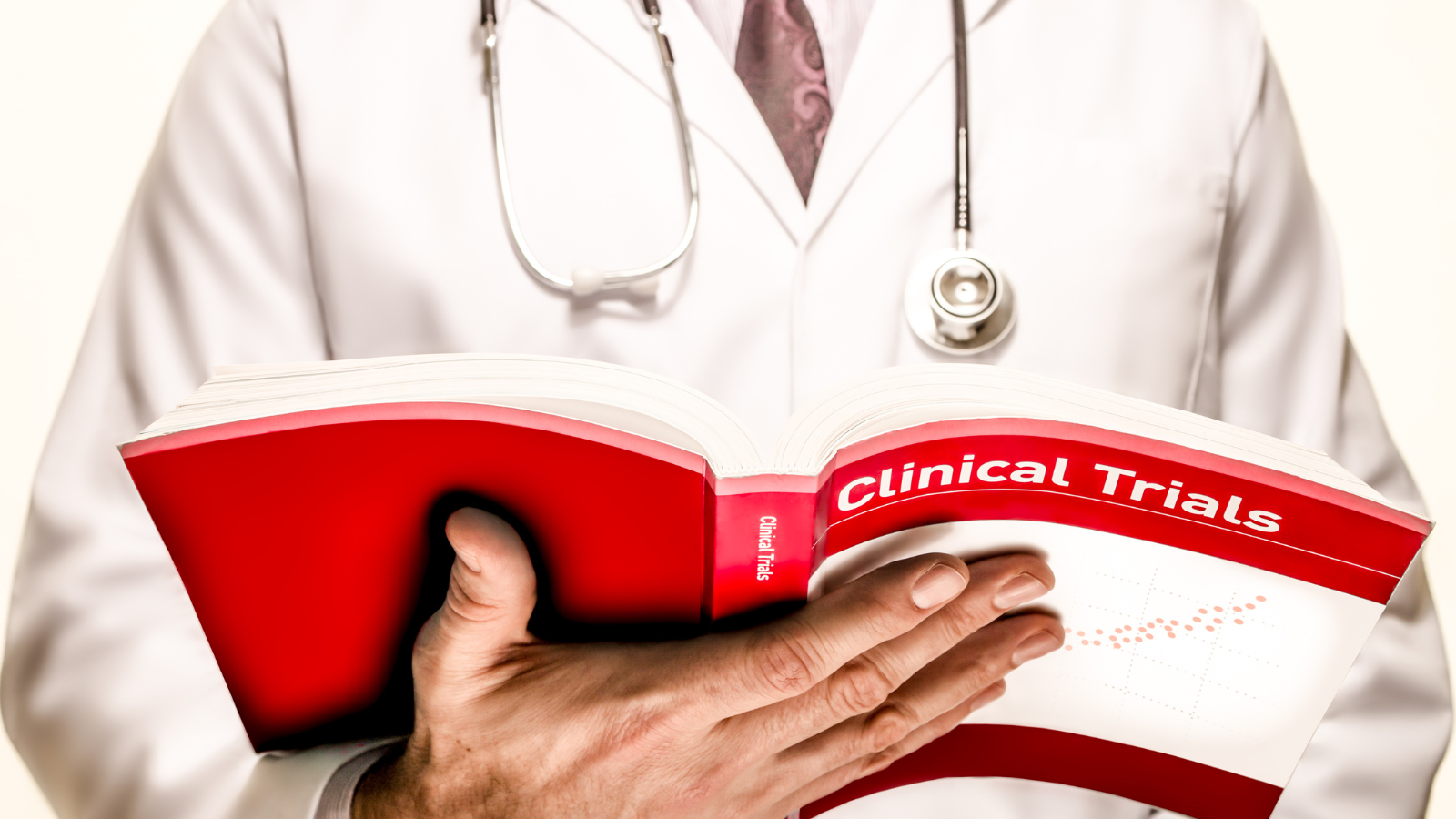 doctor holding a book on clinical trials