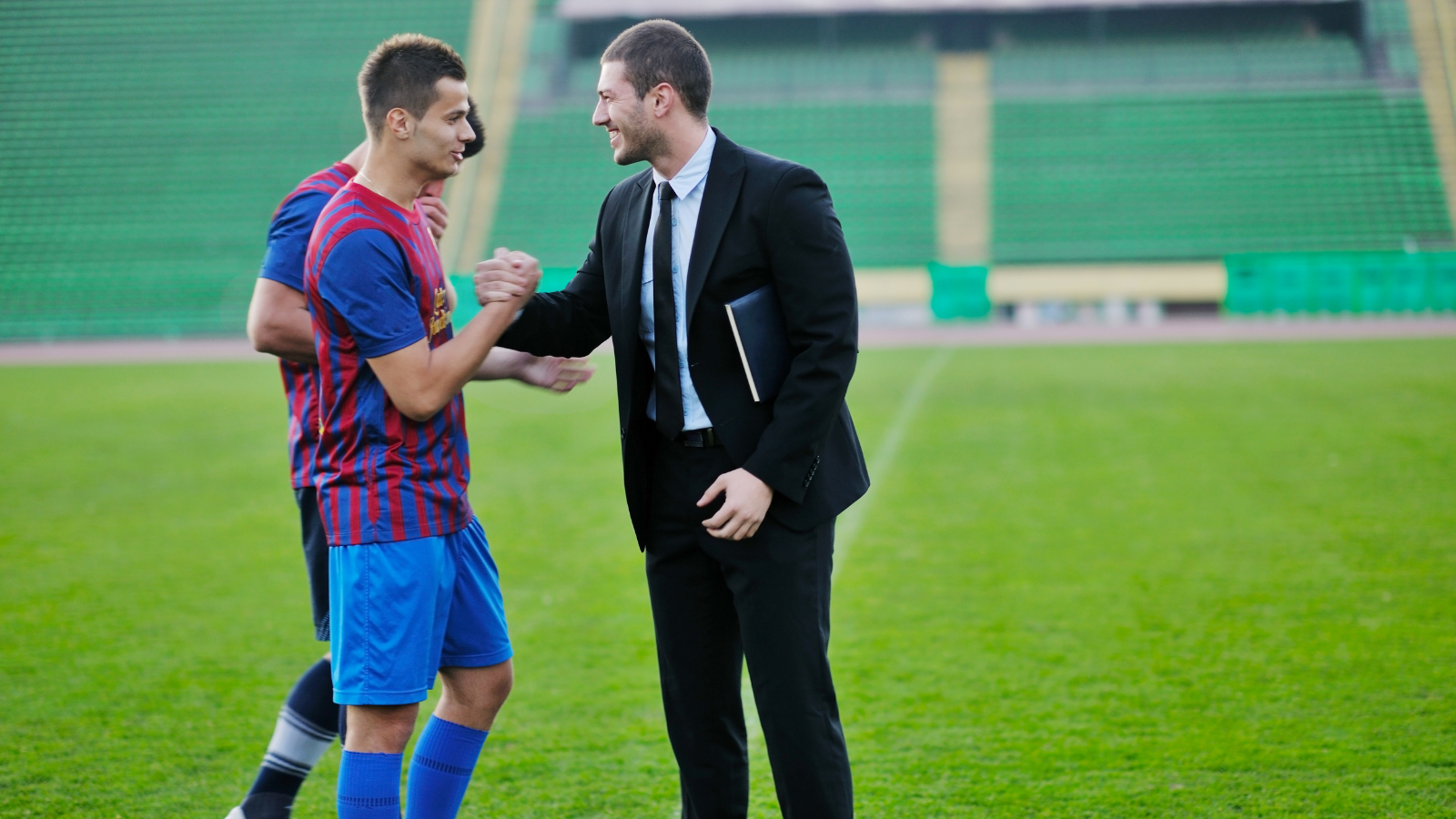 soccer player and his agent shaking hands