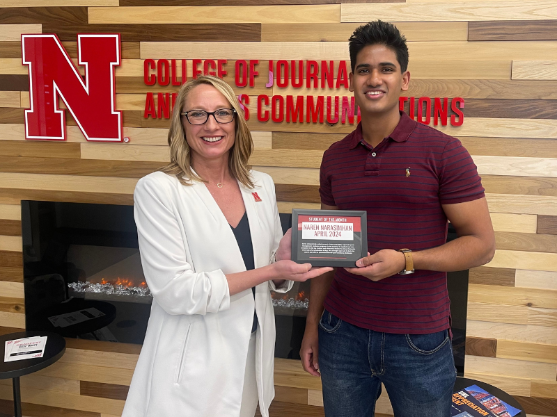 Naren Narasimhan, senior sports marketing and communications and marketing double major from Omaha (right) receives the April Student of the Month Award from Shari Veil, Jane T. Olson Dean of the College of Journalism and Mass Communications on May 1.