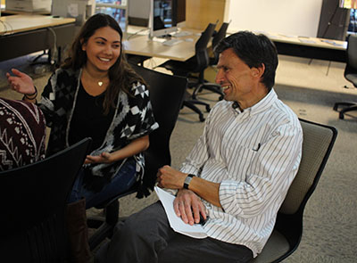 Bob Cullinan works with a student in the CoJMC during his visit