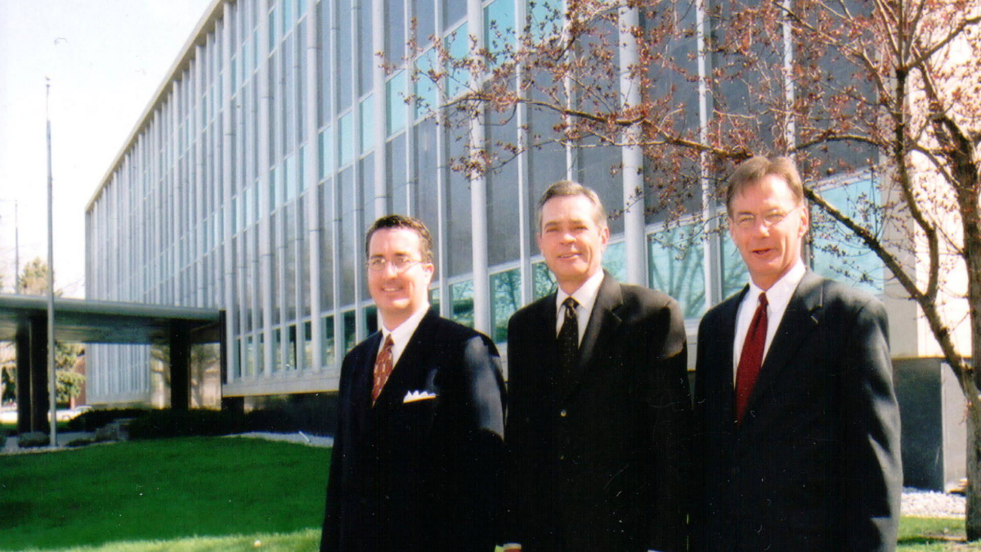 Clarey Castner, Terry Fairfield and Greg Jensen in front of the newly dedicated Andersen Hall in October 2001. 