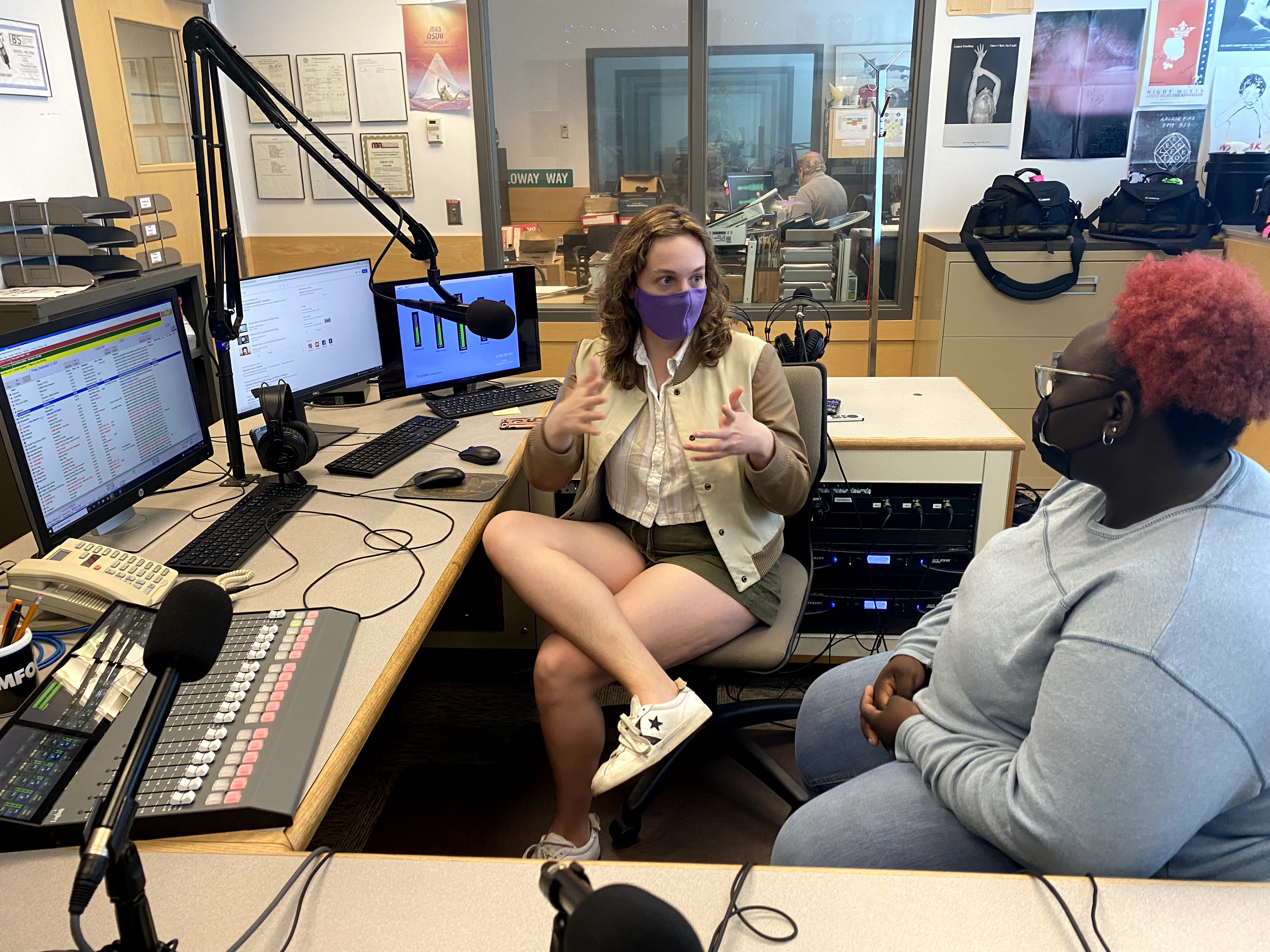 Two students talk in the campus radio station