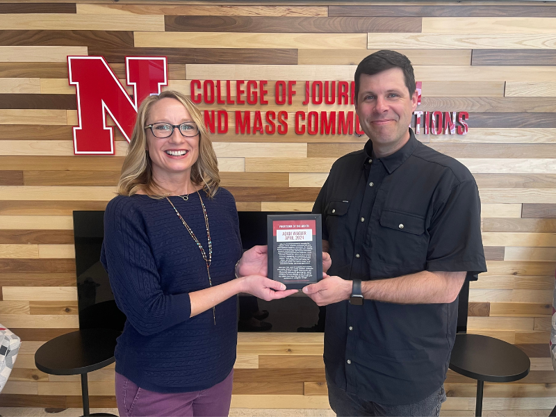 Associate Dean for Academic Programs and Associate Professor of Advertising and Public Relations Adam Wagler (right) receives the April Professor of the Month Award from Shari Veil, Jane T. Olson Dean of the College of Journalism and Mass Communications on April 29.
