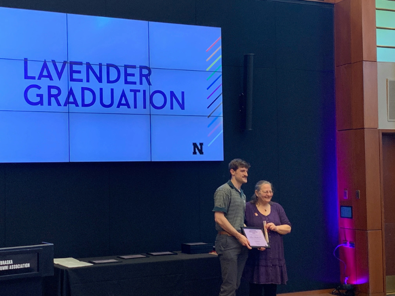 Josh Schrader is presented a Lavendar Graduation certificate by Pat Tetreault, director of the UNL LGBTQA+ Center and UNL Women’s Center on May 4. 2023. 