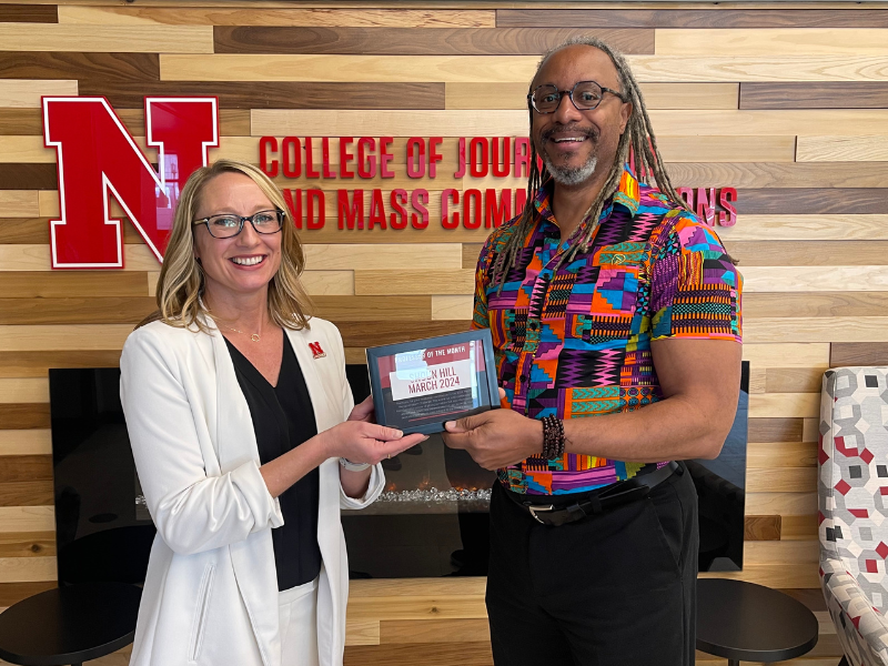 Buffett-Mangelsen-Sartore Chair and Assistant Professor of Practice Shoun Hill (right) receives the March Professor of the Month Award from Shari Veil, Jane T. Olson Dean of the College of Journalism and Mass Communications on April 9.