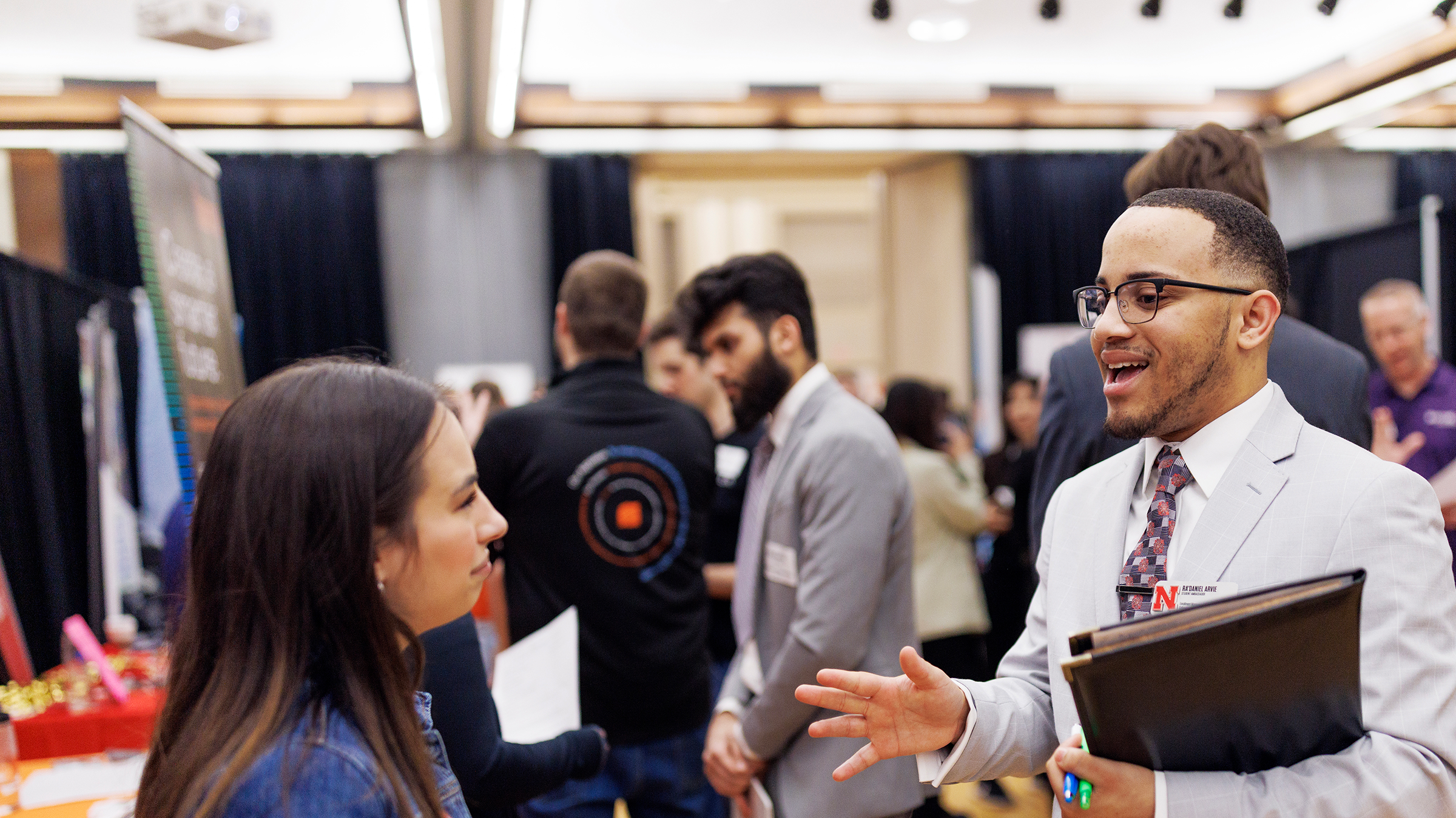 two people talk at a career fair