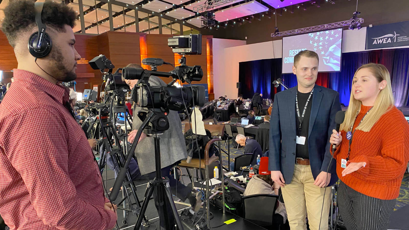 Two students stand infront of a camera talking