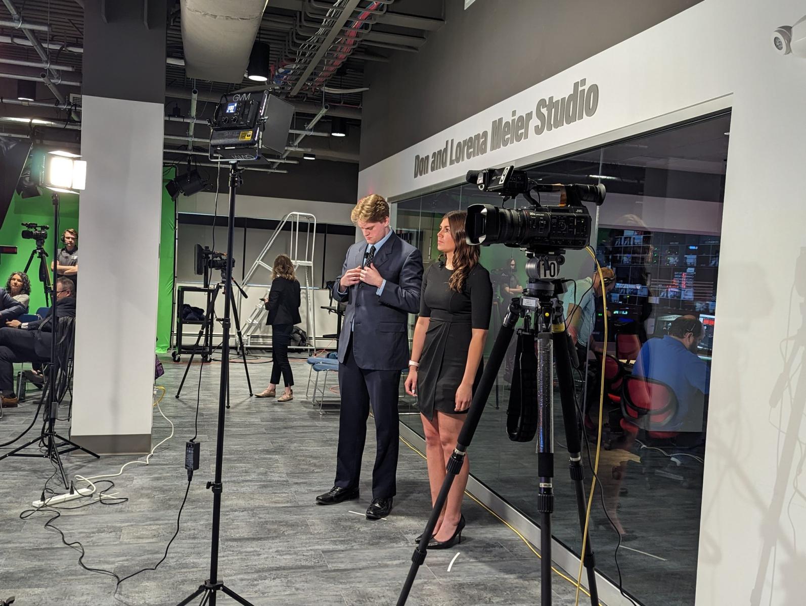 Students Lance Vie (left) and Alaina Tomesh prepare to introduce the Lincoln Mayoral Debate on April 23.