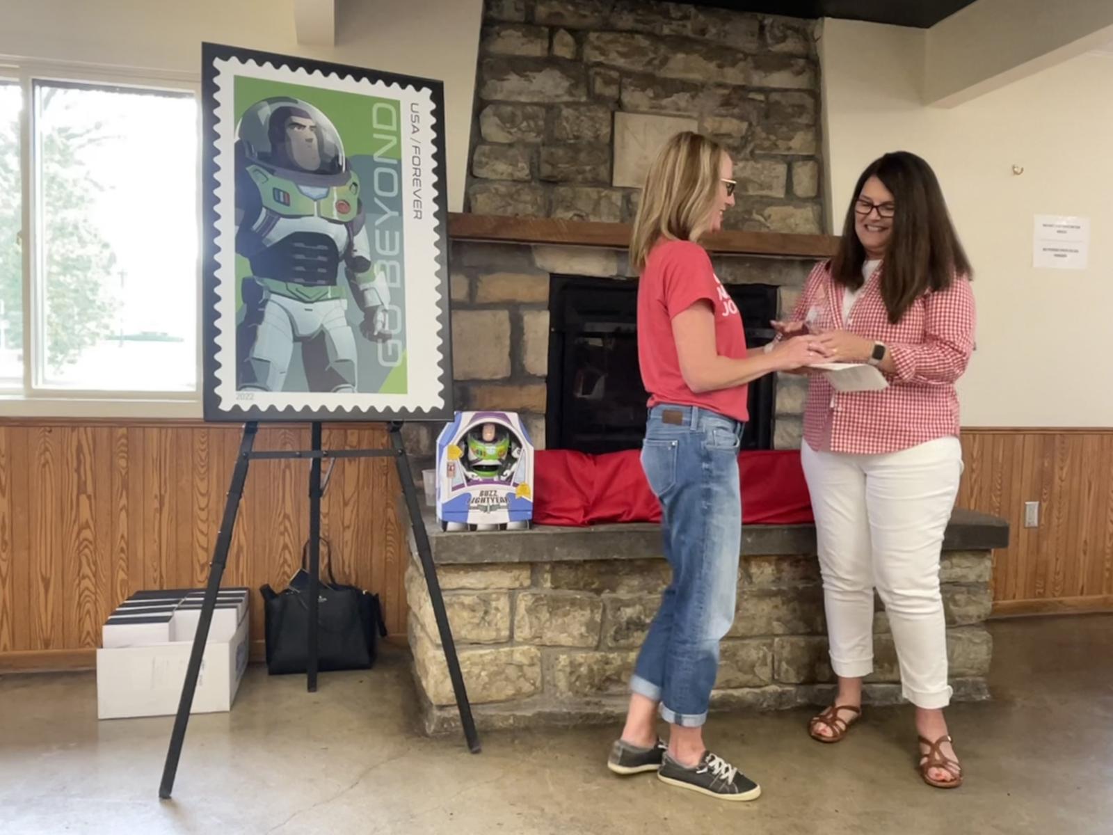 Excellence in Teaching Award recipient Michelle Hassler, associate professor of practice in journalism, receives her award from CoJMC Dean Shari Veil.