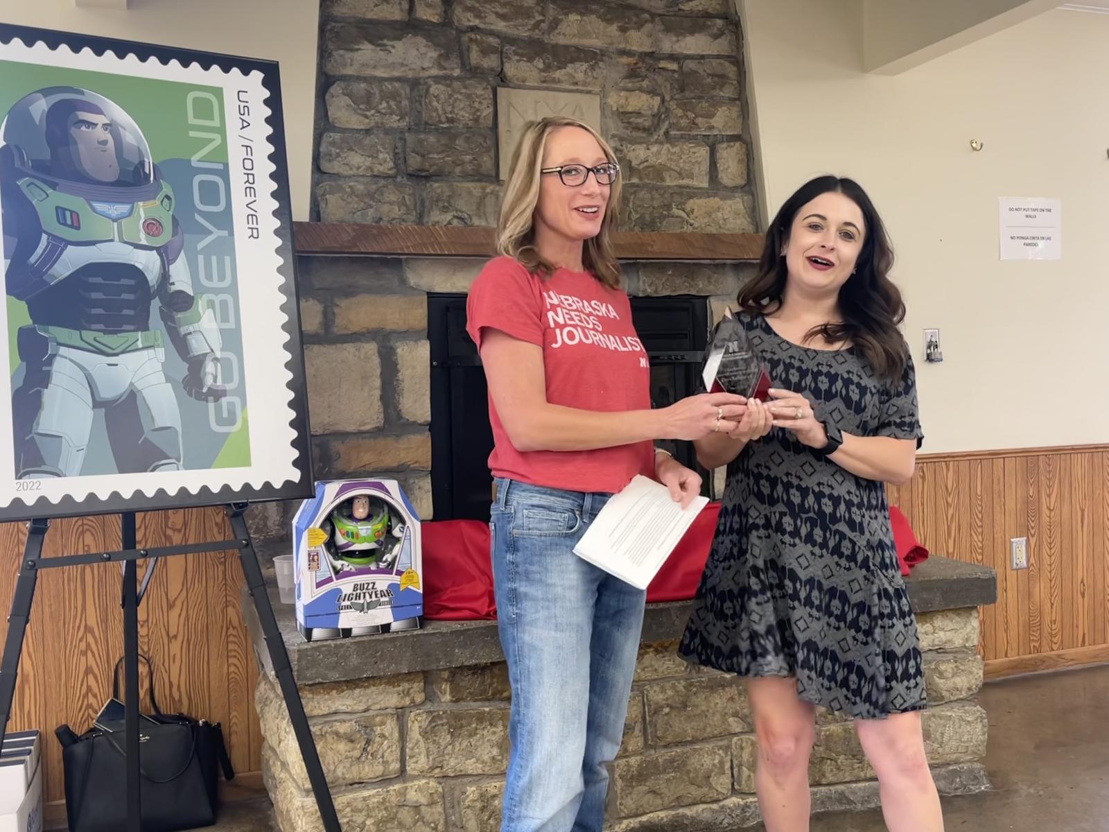 Excellence in Research/Creative Activity Award recipient Ciera Kirkpatrick, assistant professor in advertising and public relations, smiles with CoJMC Dean Shari Veil as she receives her award.