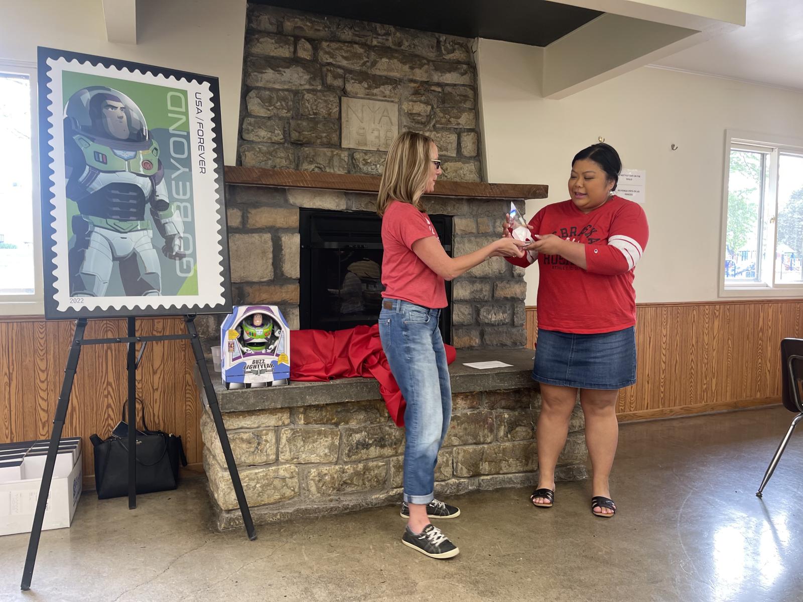 Inclusive Excellence Award recipient Jemalyn Griffin, assistant professor of practice in advertising and public relations, receives her award from CoJMC Dean Shari Veil.