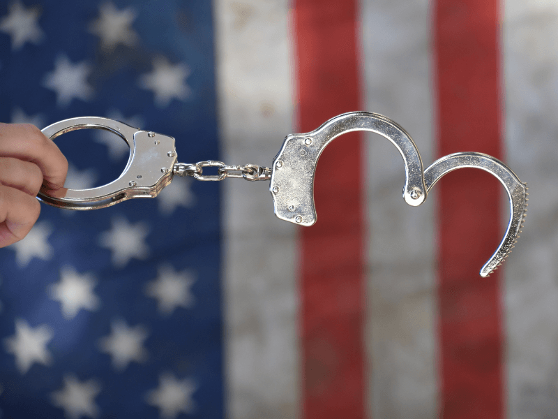 handcuffs over an American flag