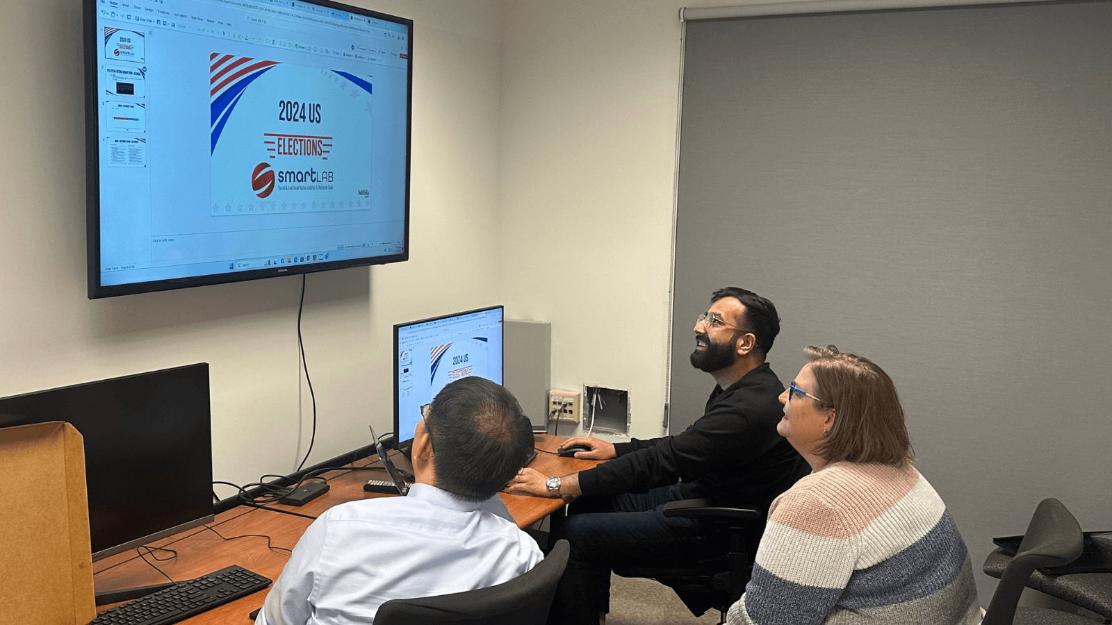 people in a classroom looking at a monitor