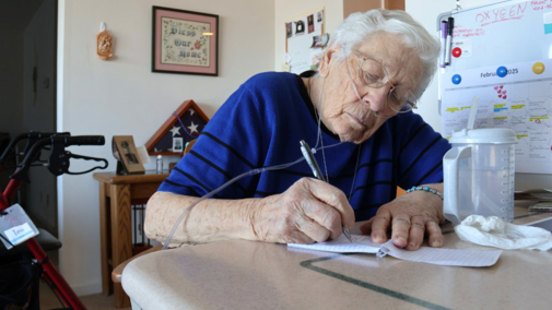 Tess Koehler (92) planning out her day, hour by hour, during her daily quiet time in her room at Gateway Vista Senior Living Facility in Lincoln, Neb. on Saturday, Feb. 22, 2025.