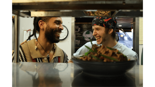 LaRue Marcos, left, shares a laugh with a program student, right, in the kitchen at 2:47 p.m. on Saturday, Feb. 21, 2026. Despite what circumstances brough them to Ooh De Lally, the workspace remains a judgement-free space where everyone is valued.