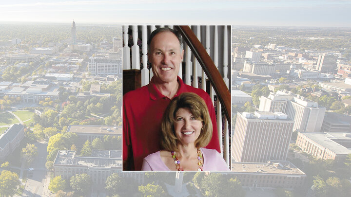 Color portrait of university benefactors Mick and Cindy McCaffery on a color campus background.