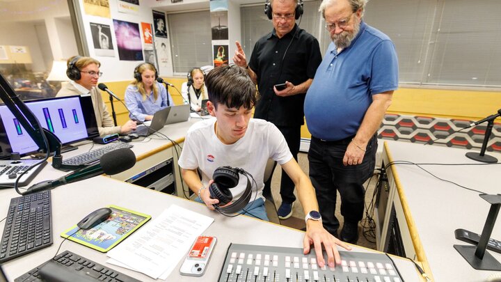 Junior Hamilton Reinbold, center, operates a broadcast console during 90.3 KRNU’s election coverage in Andersen Hall.