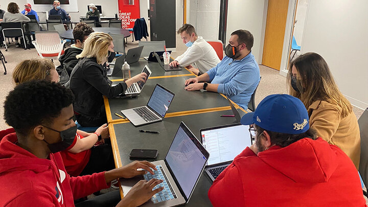 Professional-in-residence meet with students in the experience lab