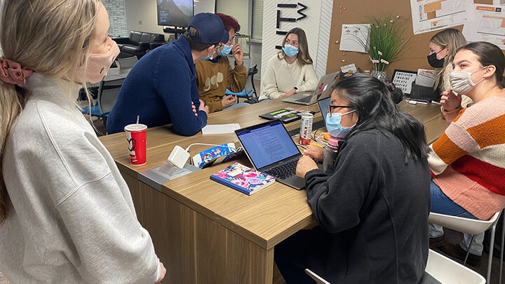 Group of students working around a table