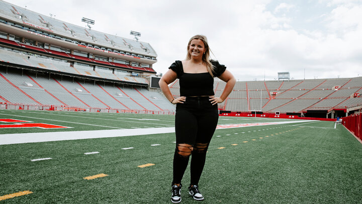 Gross on the field of Memorial Stadium. As a first-year sports media and communication major and intern with Husker Athletics, Meg is already garnering hands-on experience covering a variety of Husker sporting events.