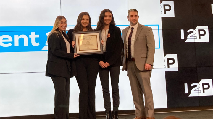 group of four people accepting an award