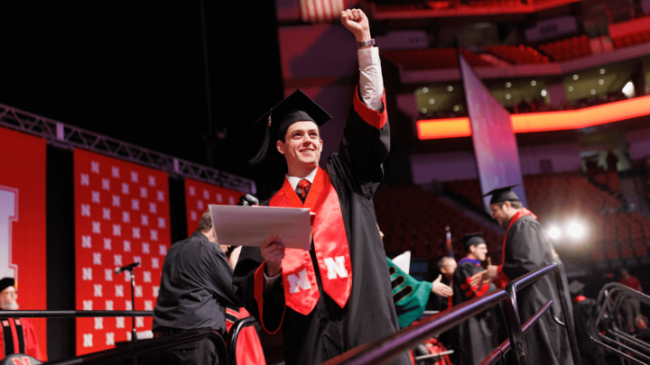 Ryan Yetts (’22) celebrates getting his degree at Pinnacle Bank Arena in Dec. 2022. The arena will host a combined graduate and undergraduate commencement ceremony Aug. 17.