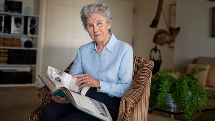 Woman sits in her living room