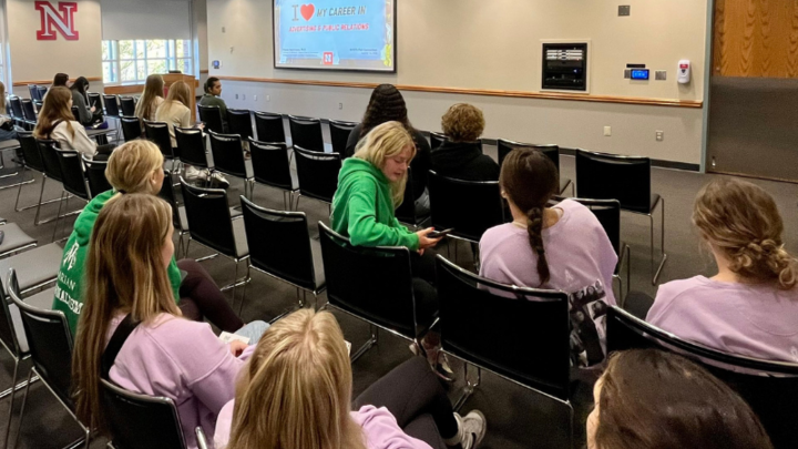 Students sitting watching a presentation