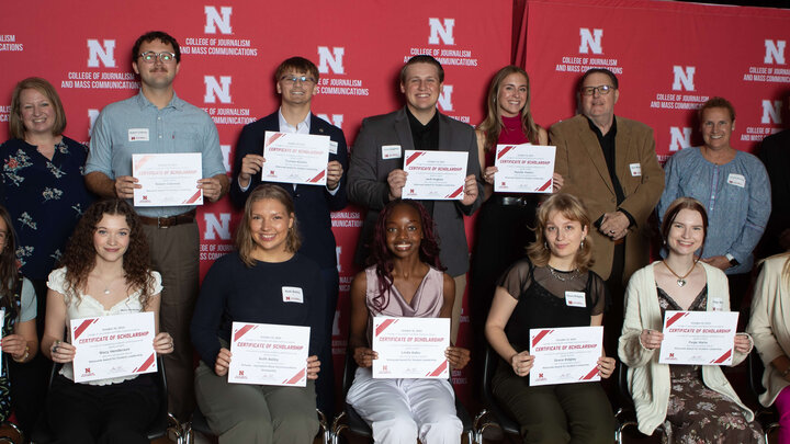 students with scholarship certificates