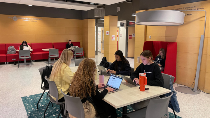 (From back right moving clockwise): Students Regan Lambe, Shayla Ath, Maddy Wallor and Grace Harper work on a project for their advertising and public relations class.