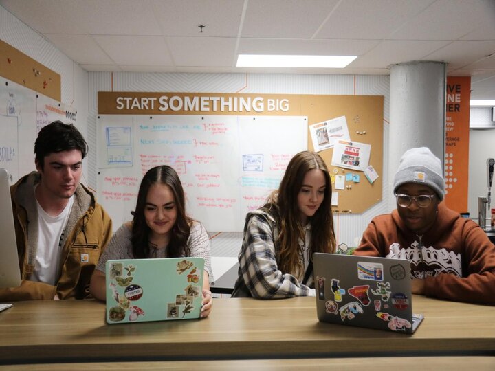 Students working in The Agency