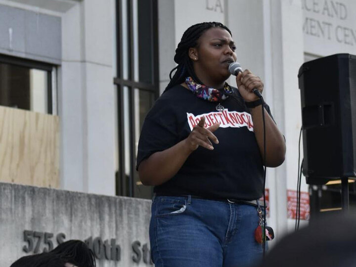 A student speaking into a microphone