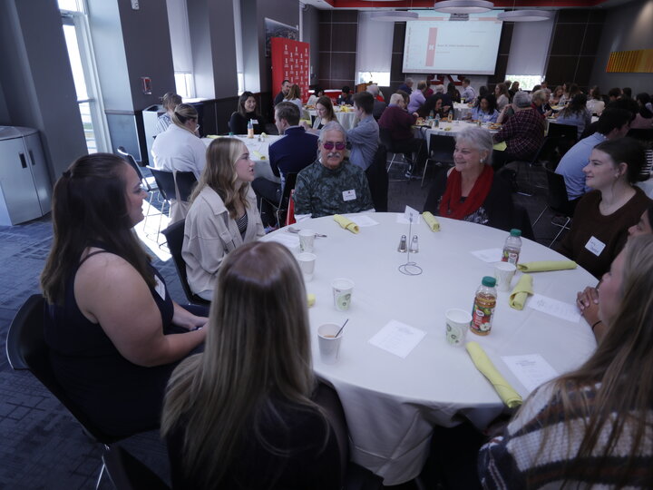 gruop of people sit around a table