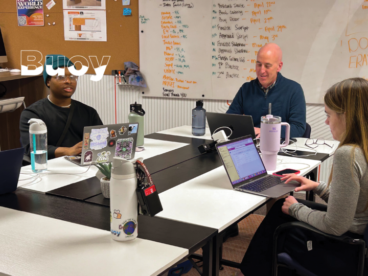 Three people work around a table