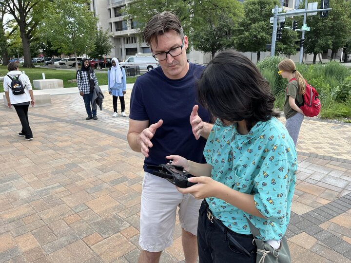 Matt Wait talking with a student