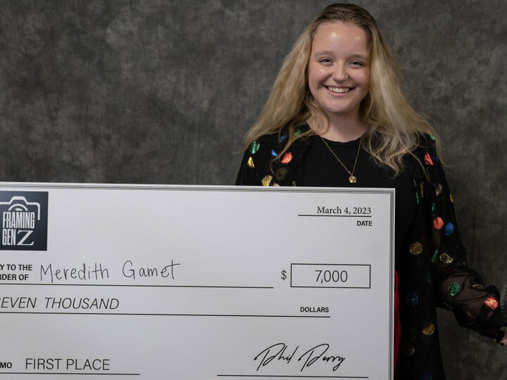 Meredith Gamet holding a big check