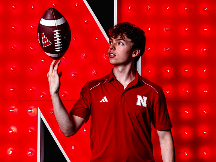 man spinning a football on his finger