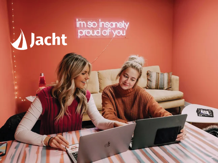 Two women work together at a computer