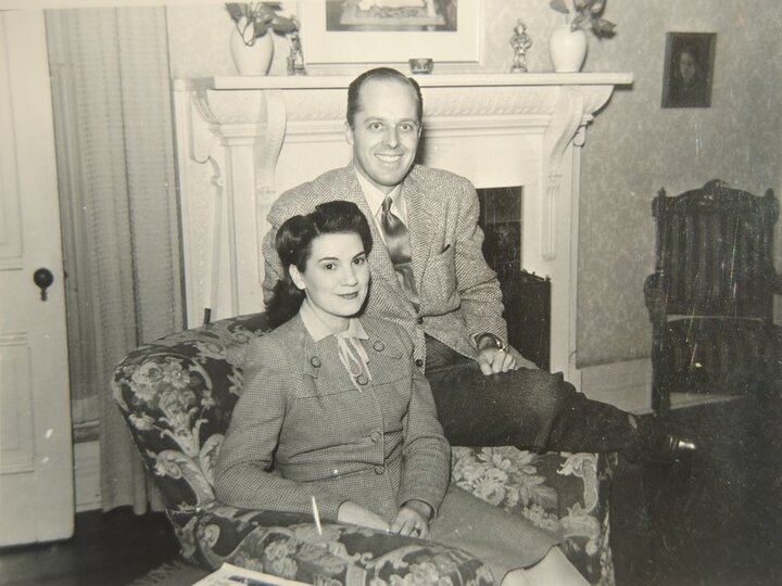 Two people sit in a living room