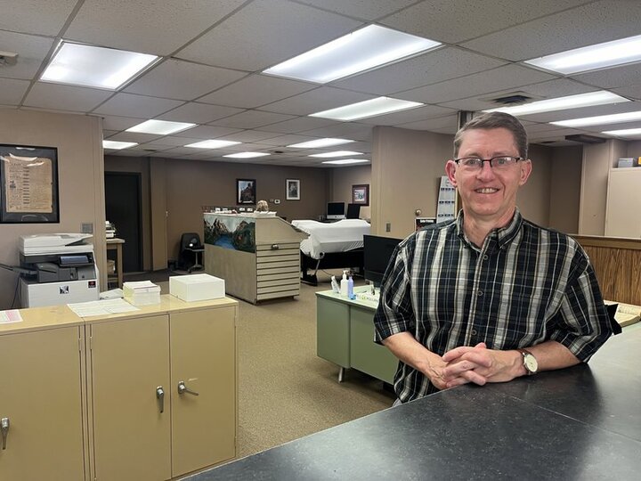 Kurt Johnson, publisher of the Aurora News-Register, stands inside the newspaper office on K Street. Johnson said it can be difficult to find journalists willing to work at rural newspapers. The News-Register is one of 203 local and state news organizations in the state. (Jessica Walsh / UNL)