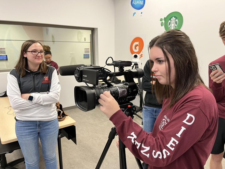 Hannah Roebke helping her mentee with a video camera